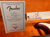 Fender Certificate of Authenticity for 1966 Stratocaster NOS with serial number R28875 and Fender Custom Shop inspection tag in orange guitar case background