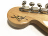 Close-up of Fender Custom Shop guitar headstock with tuning pegs and natural wood finish