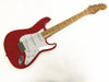 Red Fender Stratocaster electric guitar with maple neck and white pickguard on white background