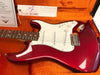 1966 Fender Stratocaster NOS electric guitar in candy apple red finish with white pickguard and rosewood fretboard, displayed in orange plush-lined case with Fender Custom Shop tags and certificate