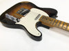 Vintage sunburst electric guitar with worn finish, chrome hardware, white pickguard, and maple neck on white background