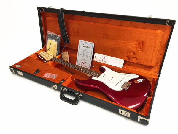 Fender electric guitar in candy apple red finish with white pickguard in vintage black hard case with orange plush interior including certificate of authenticity and accessories