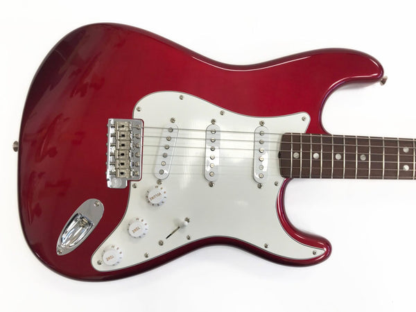 Red electric guitar with white pickguard and three single-coil pickups, rosewood fretboard, and chrome hardware on white background.