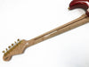 Back view of electric guitar neck with maple wood, gold tuning pegs, and red guitar body on white background