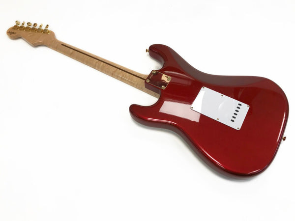 Back view of red electric guitar with maple neck and white backplate on white background