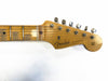 Close-up of a vintage Fender Stratocaster guitar headstock and fretboard with tuning pegs and maple wood finish