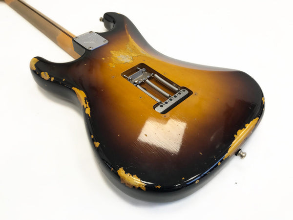 Vintage sunburst electric guitar body with visible wear and chipped paint, back view showing tremolo springs and neck plate on white background