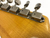 Close-up of vintage Kluson guitar tuning pegs on yellow wood guitar headstock
