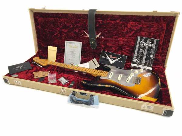 Fender Custom Shop vintage sunburst Stratocaster guitar in beige hard case with red plush interior, including Fender certificate of authenticity, owner's manual, extra parts, and accessories.