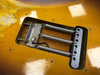 Close-up of vintage electric guitar tremolo cavity showing three metal springs and wiring on worn yellow guitar body