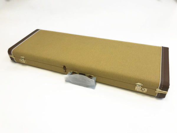 Vintage tweed guitar hard case with brown leather corner reinforcements and metal latches on white background