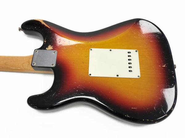 Vintage sunburst electric guitar body with white backplate and chrome neck plate showing wear and scratches