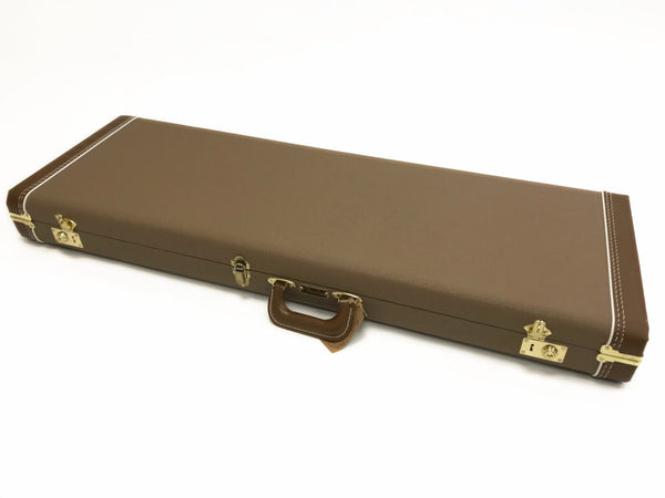 Brown rectangular hard shell guitar case with leather handle and brass hardware locks on white background