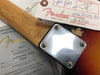 Close-up of Fender 59 Stratocaster Relic guitar neck joint with serial number R65660 on metal plate, sunburst finish, Fender certificate of authenticity, and Fender hang tag with part and serial numbers visible.