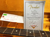 Fender Custom Shop Certificate of Authenticity and parts tag for '59 Stratocaster Relic with serial number R65660 inside orange plush guitar case with guitar fretboard visible