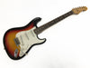 Vintage Fender Stratocaster electric guitar with sunburst finish, white pickguard, and rosewood fingerboard, shown on white background