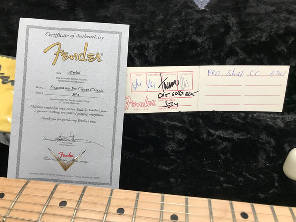 Fender Certificate of Authenticity for Stratocaster Pro Closet Classic guitar dated 08/31/06 with Fender Custom Shop tag and part number 3514 displayed on black plush background next to maple guitar fretboard.