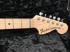 Fender Stratocaster maple neck and headstock with chrome tuning pegs on black plush background