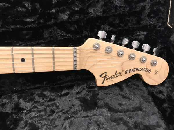 Fender Stratocaster maple neck and headstock with chrome tuning pegs on black plush background