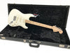 Fender Stratocaster electric guitar in white finish with maple neck and fingerboard, displayed inside black plush-lined Fender hard case