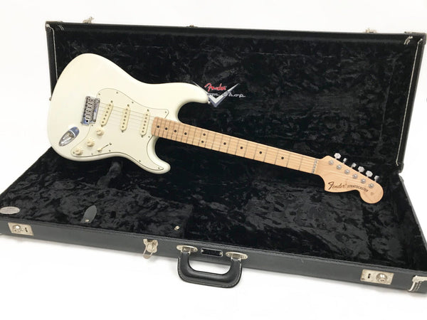 Fender Stratocaster electric guitar in white finish with maple neck and fingerboard, displayed inside black plush-lined Fender hard case