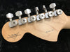Back of Fender Custom Shop guitar headstock showing six chrome tuning pegs and natural wood finish with Fender Custom Shop logo and "Pro Model 1106" inscription