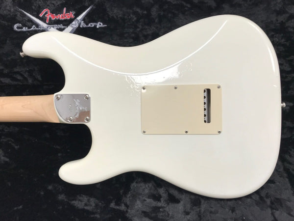 White Fender electric guitar body back with maple neck and chrome neck plate on black textured background with Fender Custom Shop logo.