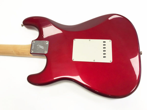 Back view of red electric guitar body with white backplate and natural wood neck, showing metal neck plate with serial number.