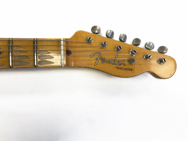 Fender Telecaster guitar headstock with vintage tuning pegs and worn fretboard on white background