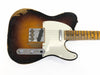Vintage sunburst electric guitar body with white pickguard and worn finish showing wood beneath