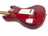 Red electric guitar body with white backplate and maple neck viewed from the back on white background