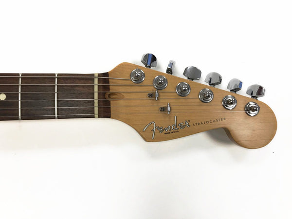 Fender Stratocaster guitar headstock with chrome tuning pegs and rosewood fretboard close-up on white background