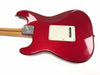 Back view of red Fender Stratocaster electric guitar with maple neck and chrome neck plate on white background