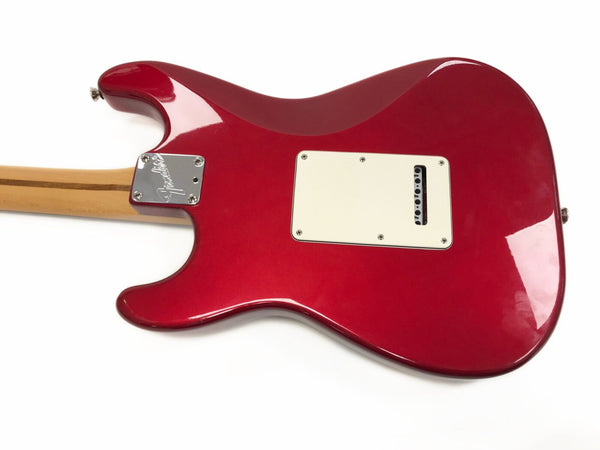 Back view of red Fender Stratocaster electric guitar with maple neck and chrome neck plate on white background