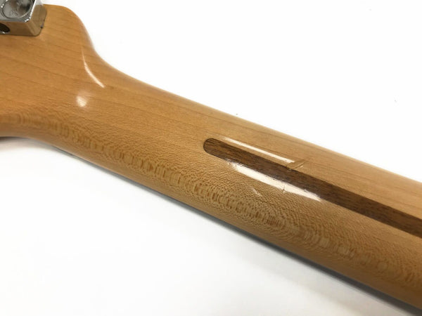 Close-up of glossy finished natural wood guitar neck with visible grain and reinforcement strip against white background