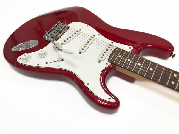 Red electric guitar with white pickguard, three single-coil pickups, and rosewood fretboard on white background