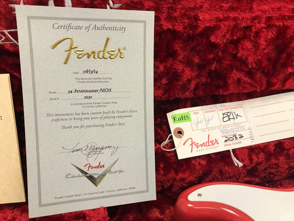 Fender Certificate of Authenticity for ’54 Stratocaster NOS with serial number 2032 and Fender Custom Shop tag on red plush guitar case lining.