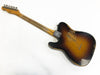 Vintage sunburst electric guitar with worn and distressed finish showing neck and back body on white background
