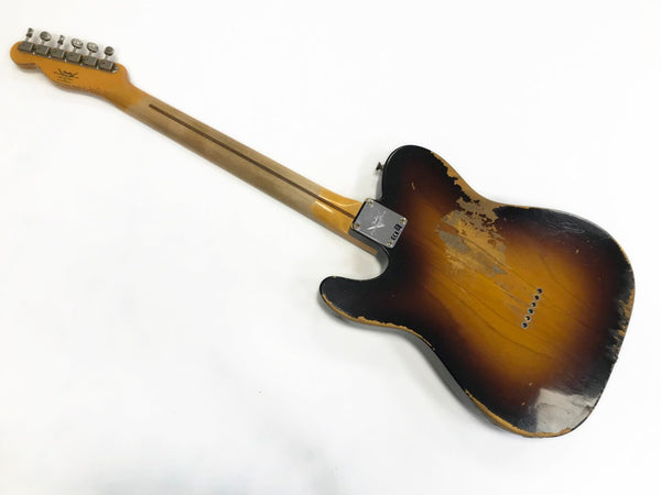 Vintage sunburst electric guitar with worn and distressed finish showing neck and back body on white background