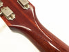 Close-up of glossy mahogany guitar neck and vintage tuning pegs on white background