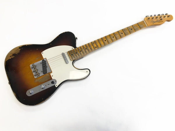 Fender Telecaster electric guitar with sunburst finish and vintage wear showing aged wood and hardware