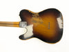 Vintage sunburst electric guitar body with heavy wear and relic finish showing wood grain and string ferrules, attached maple neck with skunk stripe on white background