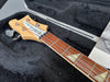 Korean Radel electric bass guitar close-up of headstock and fretboard with triangle inlays in black guitar case interior