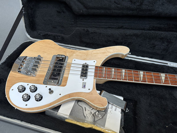 Vintage natural finish electric bass guitar with white pickguard, four control knobs, and triangular inlays on rosewood fretboard in black plush-lined hard case