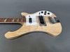 Natural finish electric bass guitar with rosewood fretboard, white pickguard, four control knobs, and chrome bridge on gray background