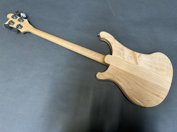 Back view of natural wood electric bass guitar with maple neck and chrome tuning pegs on gray background