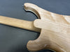 Close-up of smooth natural wood finish on the back and neck joint of a Coffee House Guitars electric guitar showing maple wood grain and contour.