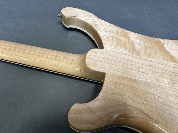 Close-up of smooth natural wood finish on the back and neck joint of a Coffee House Guitars electric guitar showing maple wood grain and contour.