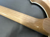 Close-up of maple guitar neck and heel joint with natural wood finish on electric guitar body
