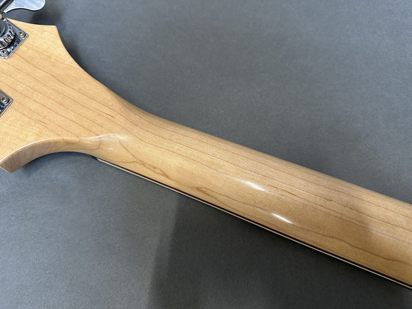 Close-up of smooth natural wood maple guitar neck on gray background, showcasing grain and finish at Coffee House Guitars product listing